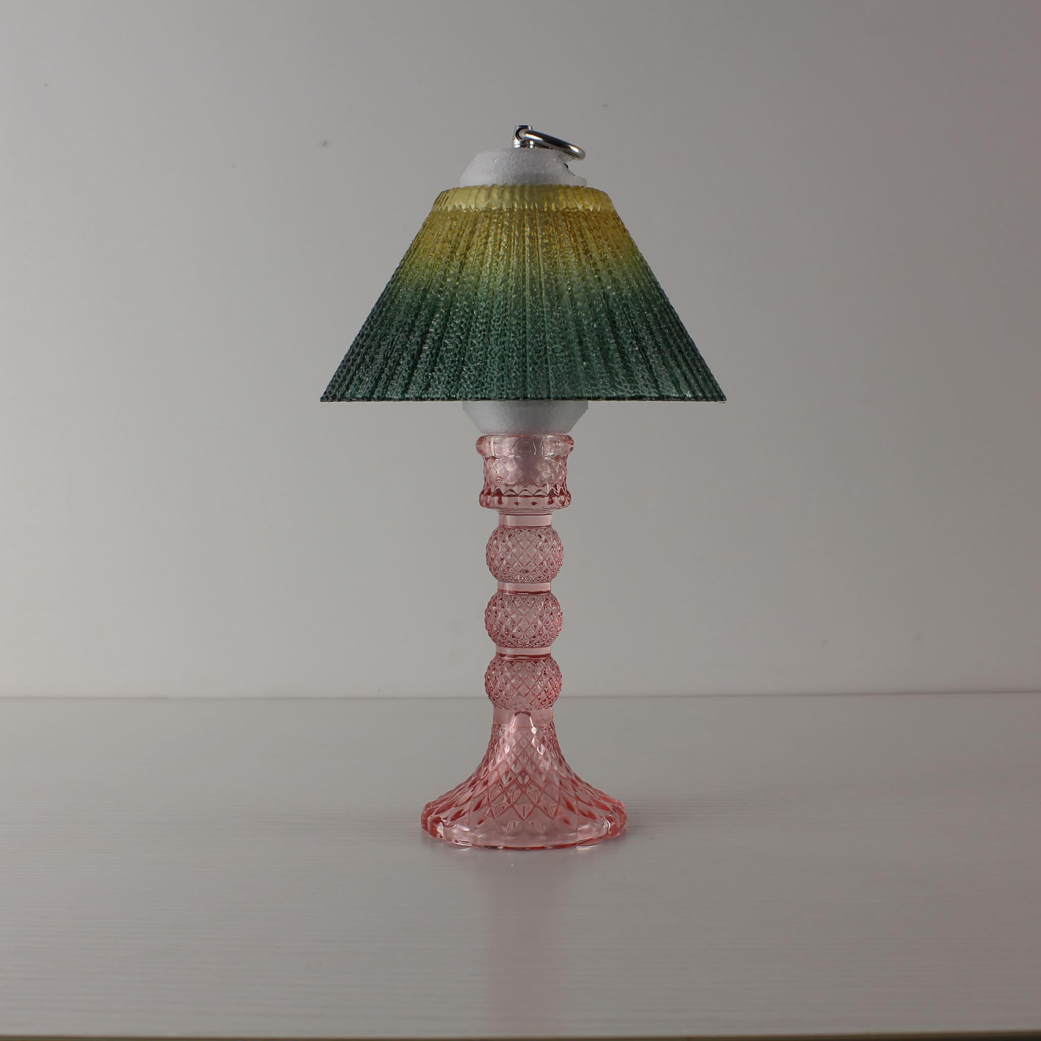 An amber to green gradient textured glass lamp. This cordless, battery-operated light is designed to enhance the ambiance of high-end commercial lounges.