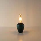 Artisanal cordless tea caddy lamp in deep kiln-turned green ceramic glaze, equipped with an elongated T125 vintage Edison bulb