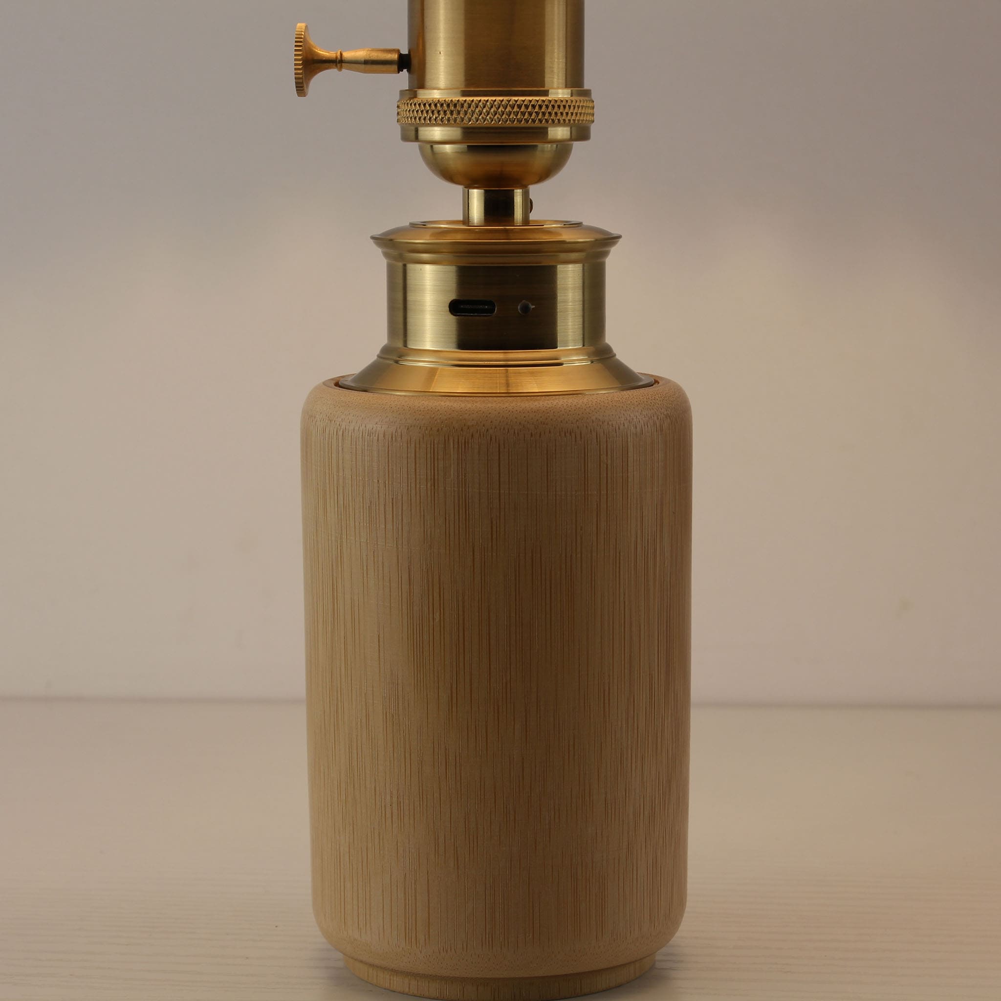 Close-up detail of Bamboo Base Lamp showing USB-C Charging Port, Vintage Brass Knob Switch, and Pleated Shade