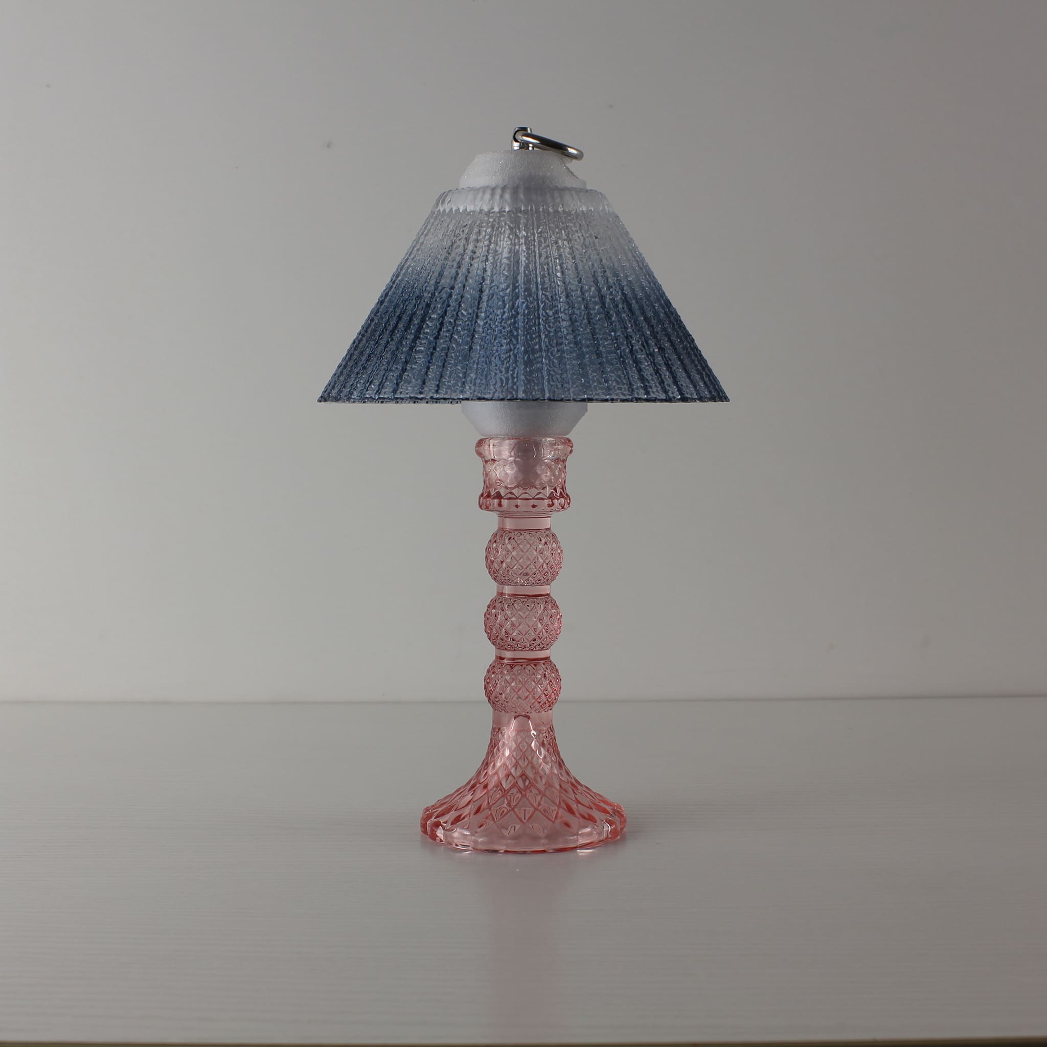 A blue-grey textured glass rechargeable lantern with a pink crystal-style base, a perfect cordless lighting solution for commercial restaurant centerpieces.