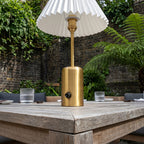 Rechargeable brass restaurant table lamp with a pleated lampshade