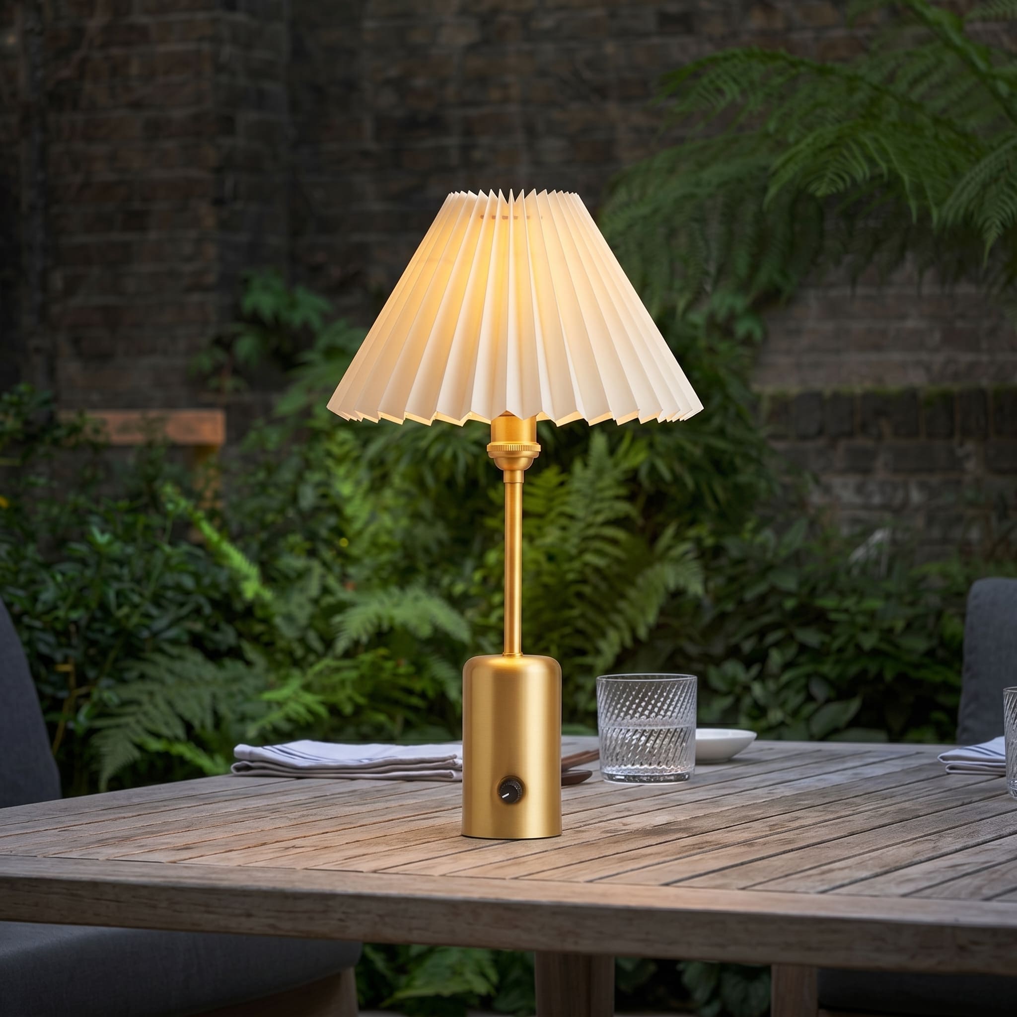 Brass cordless restaurant table lamp on an outdoor dining table