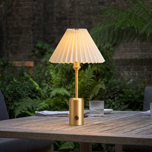 Brass cordless restaurant table lamp on an outdoor dining table