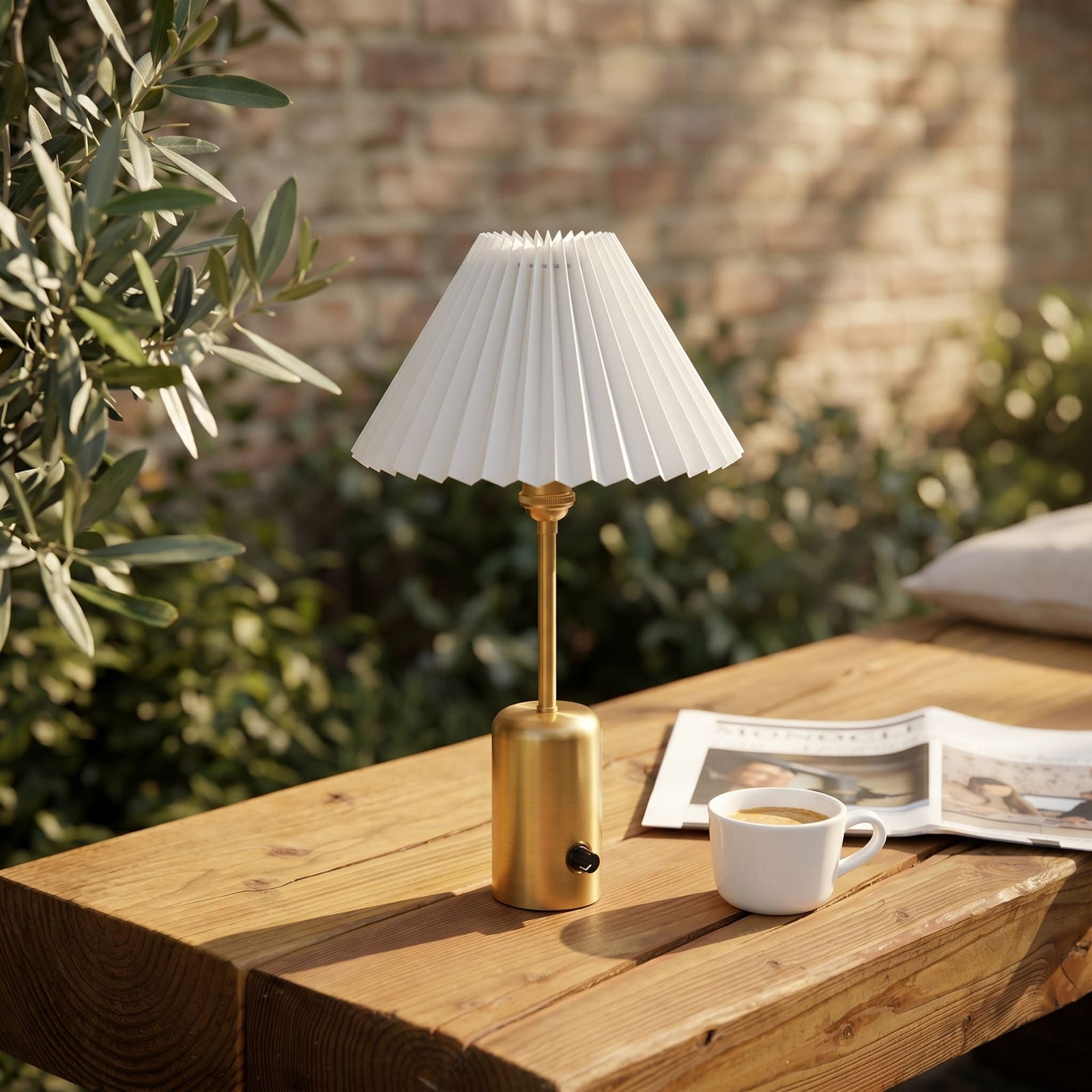 Brass cordless table lamp creating ambient lighting on a city balcony at dusk