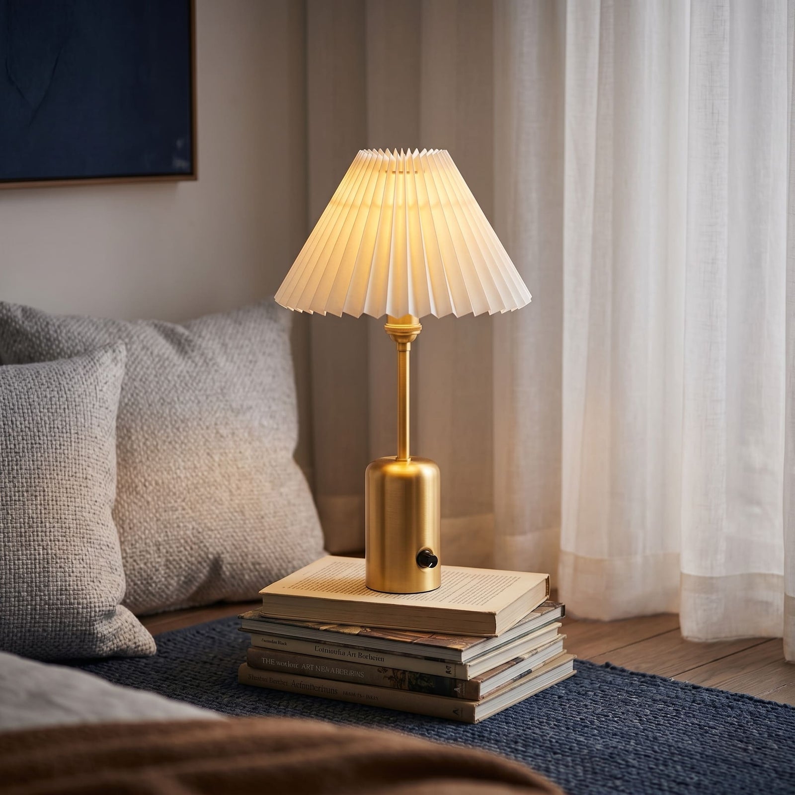 Brass cordless table lamp with a pleated shade on an outdoor coffee table