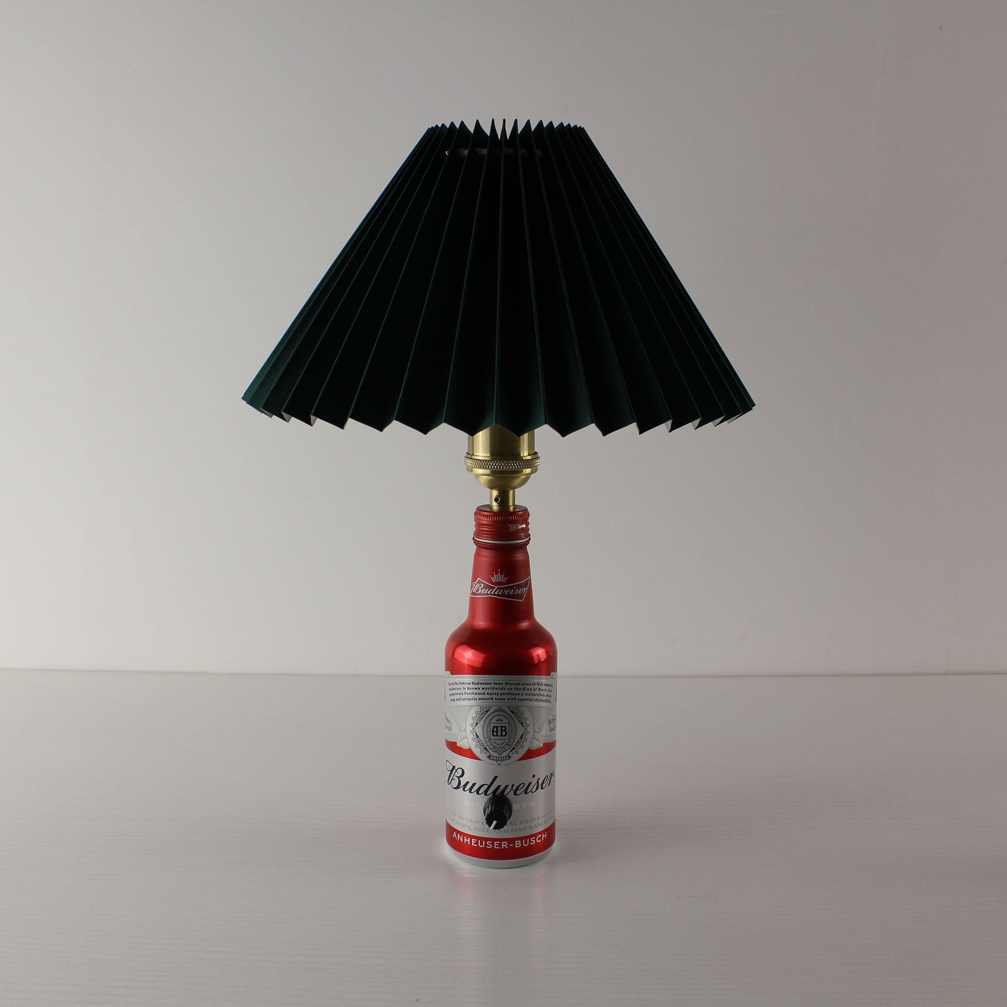Handcrafted Budweiser bottle lamp with a dark green pleated shade, perfect for home bar decor