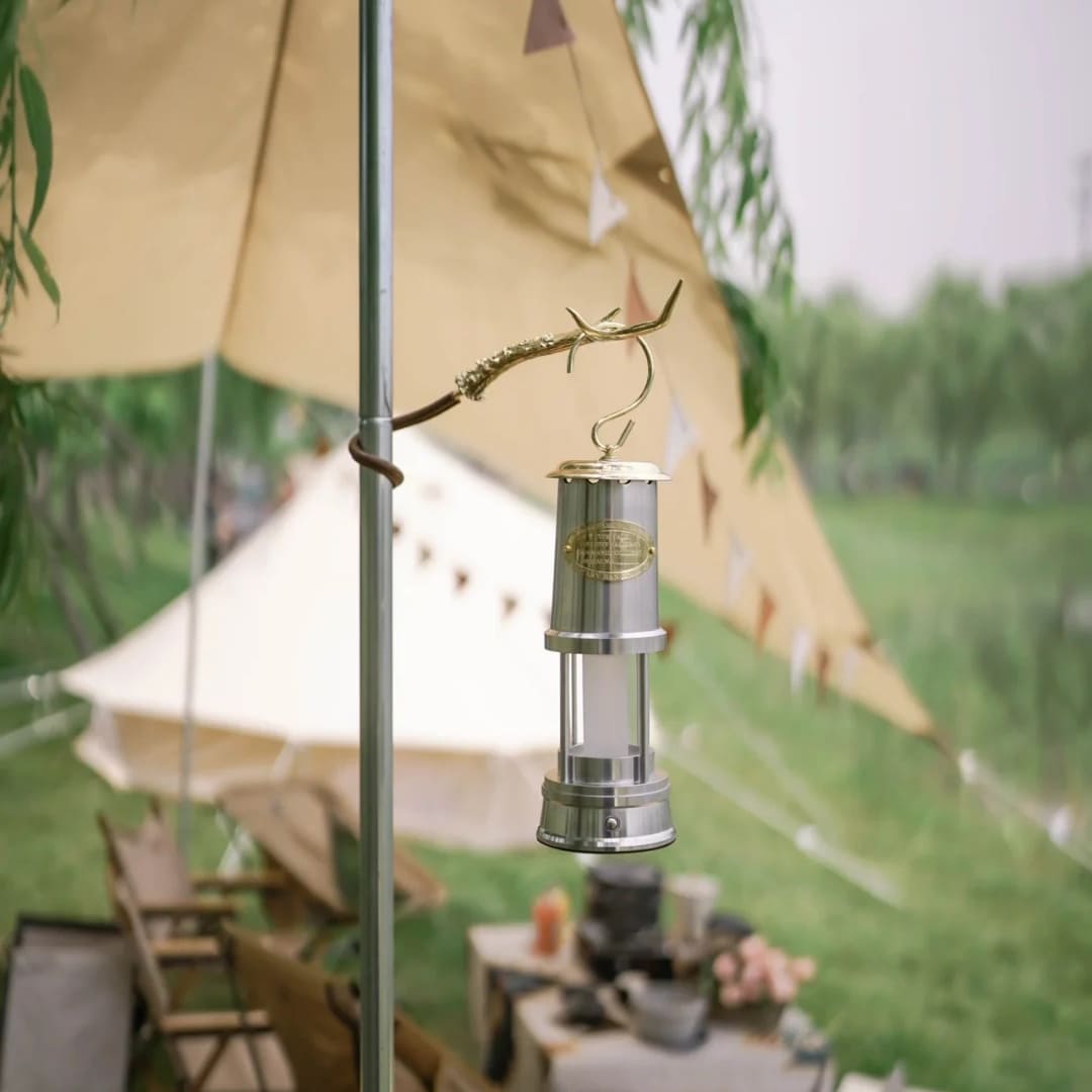 Rechargeable miner's lantern hanging outside a camping tent