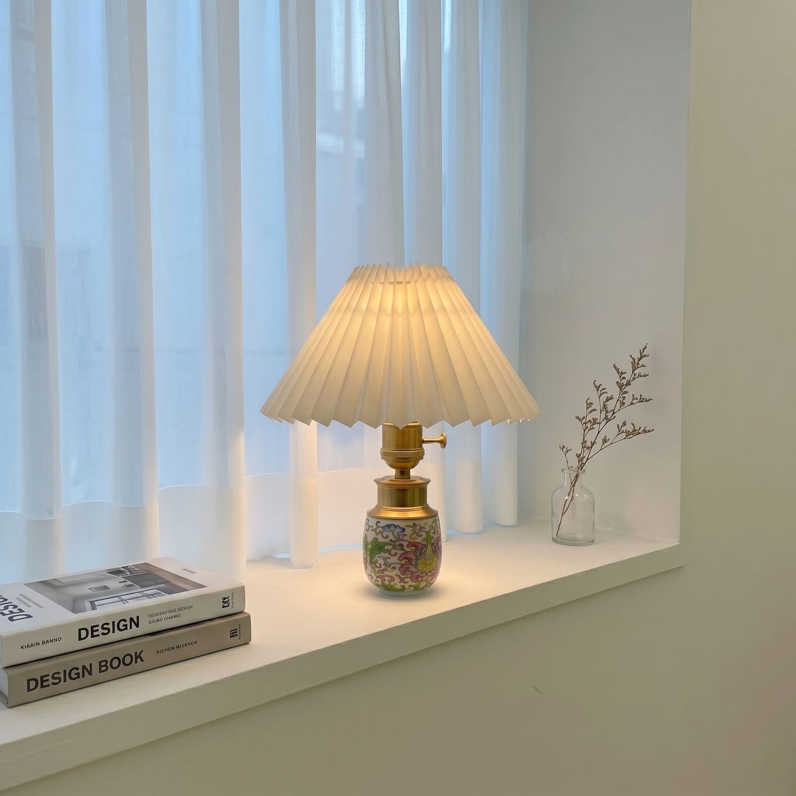 Ceramic cordless table lamp with a pleated shade placed on a window sill in a modern interior