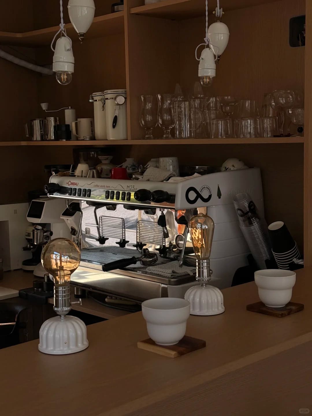 Ceramic Edison cordless lamps creating cozy lighting in a specialty coffee bar