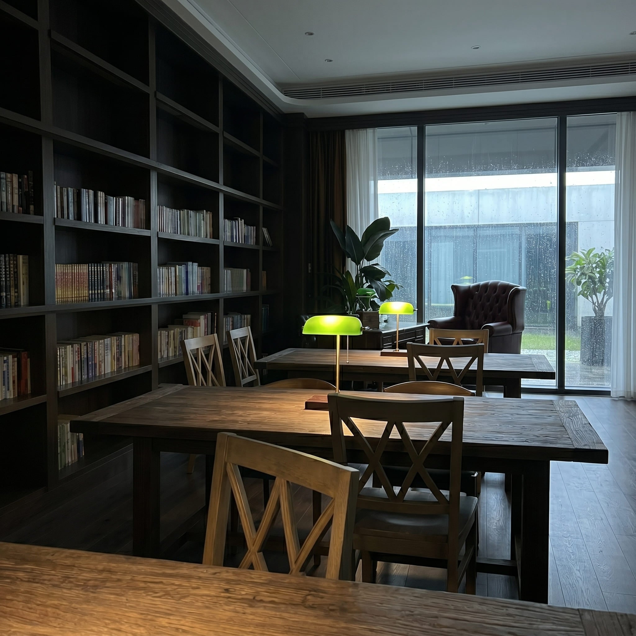Rechargeable green glass bankers lamps on study tables in a quiet library room