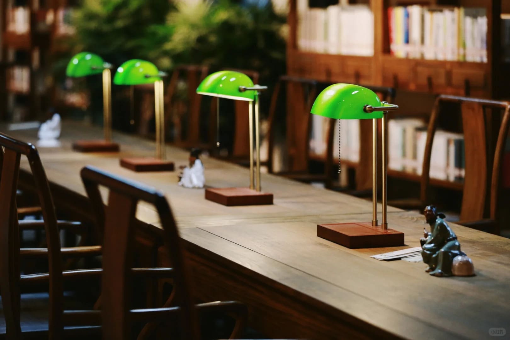 Cordless bankers lamp providing classic green shade lighting in a luxury cocktail bar