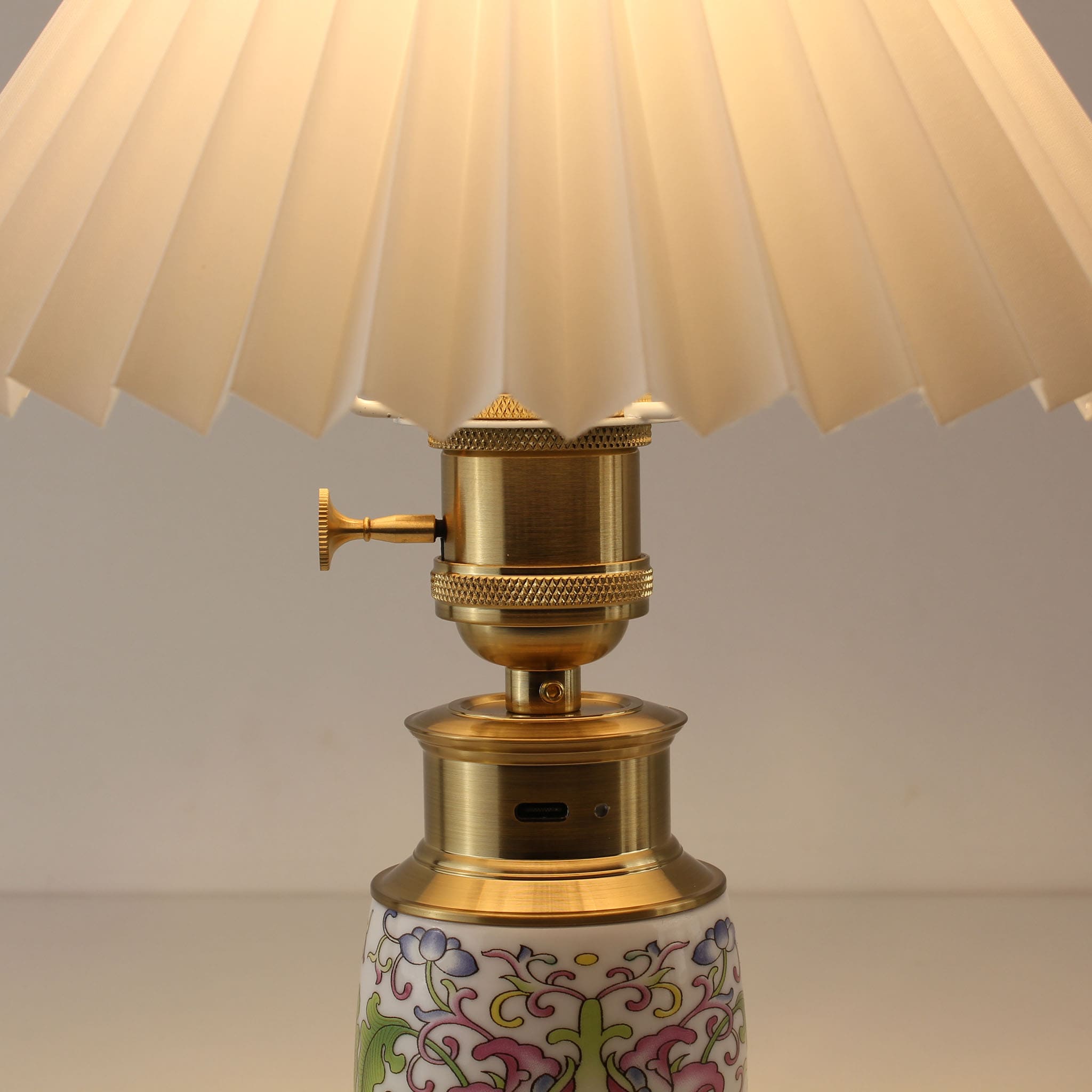 Detail view of Chinoiserie Cordless Lamp showing USB-C Charging Port, Vintage Brass Knob Switch, and Enamel Porcelain base