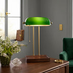 Cordless green bankers lamp with wooden base displayed on a wooden table in a classic study room