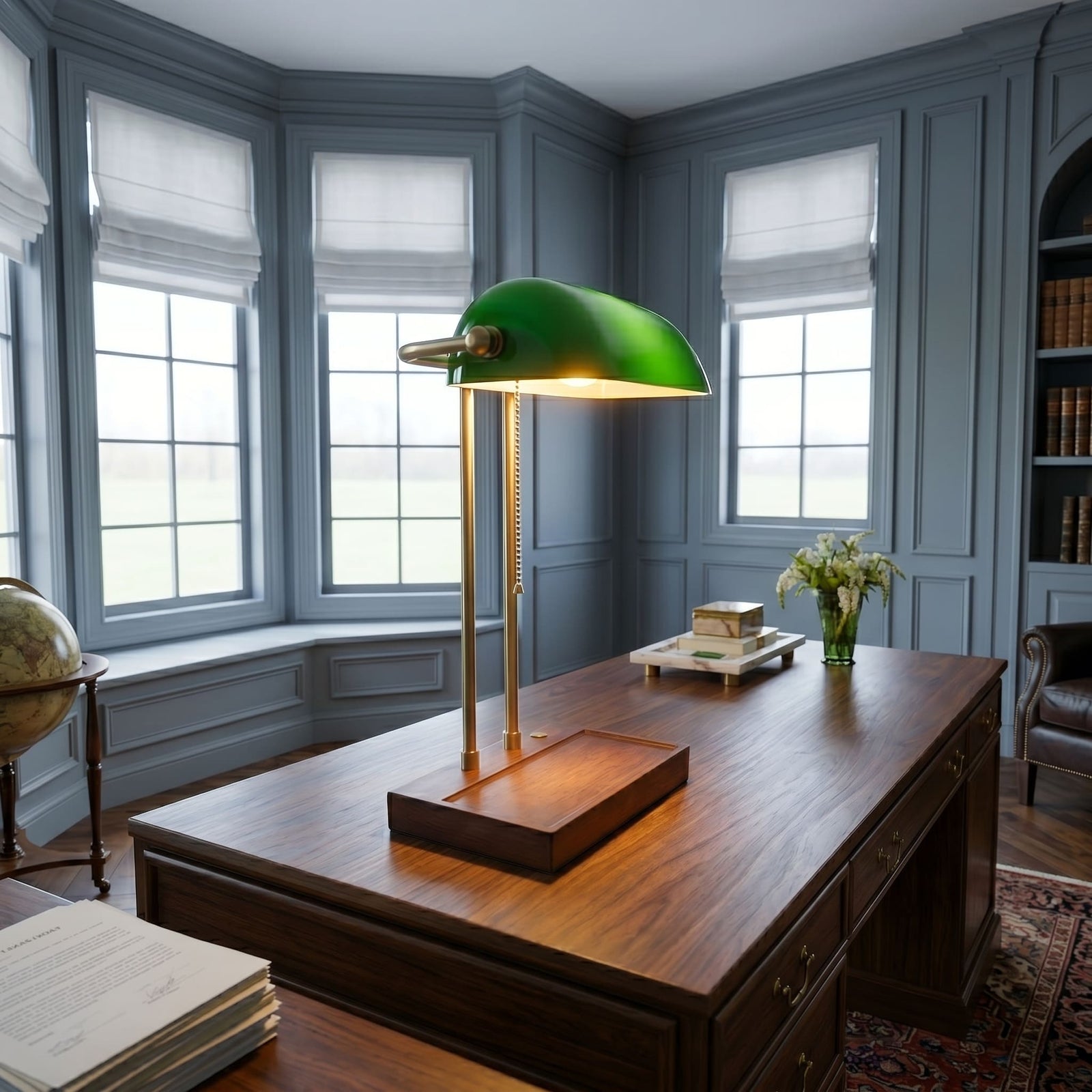 Cordless green bankers lamp with wooden base on a large executive office desk near bay windows