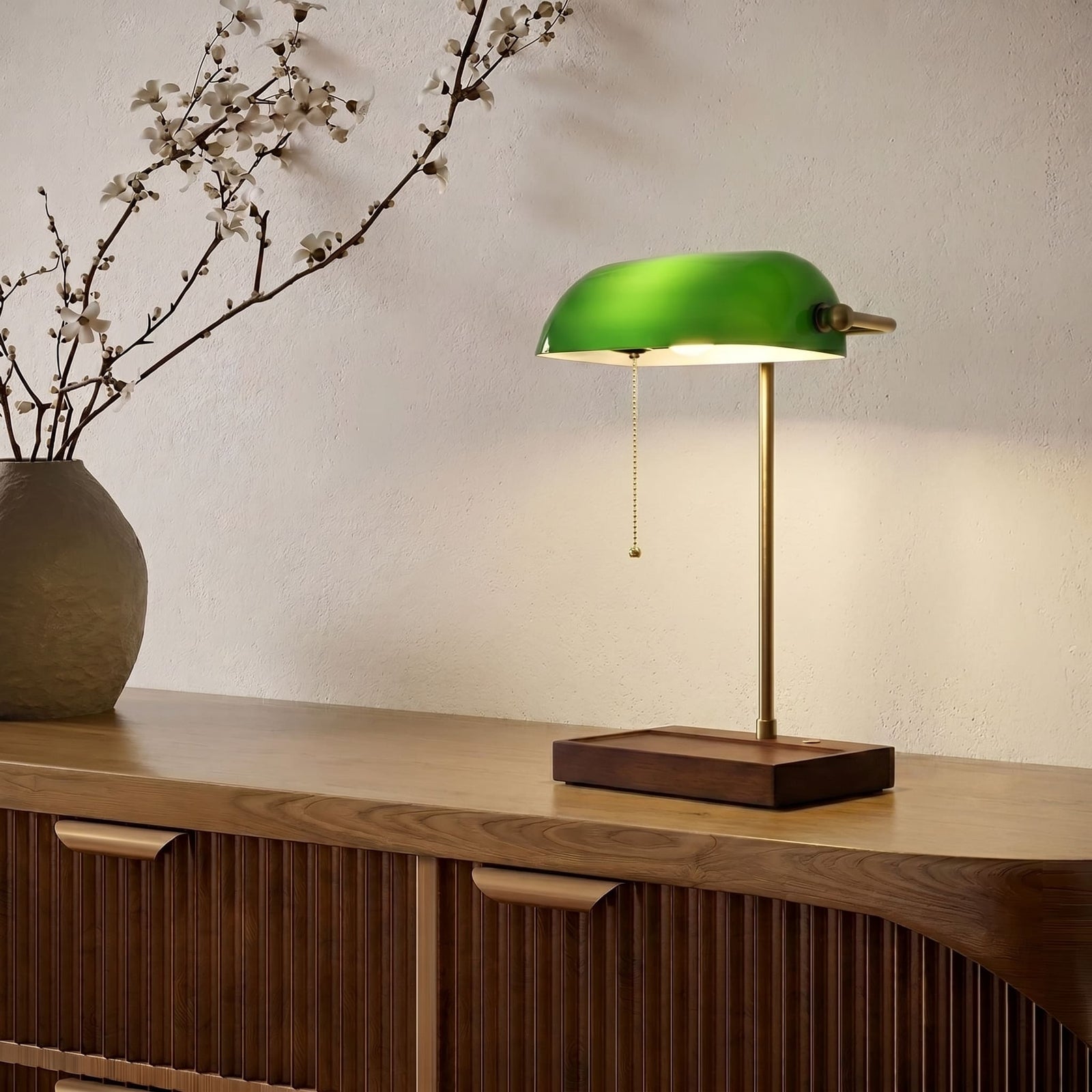 Cordless green bankers lamp with wooden base on a modern wooden sideboard