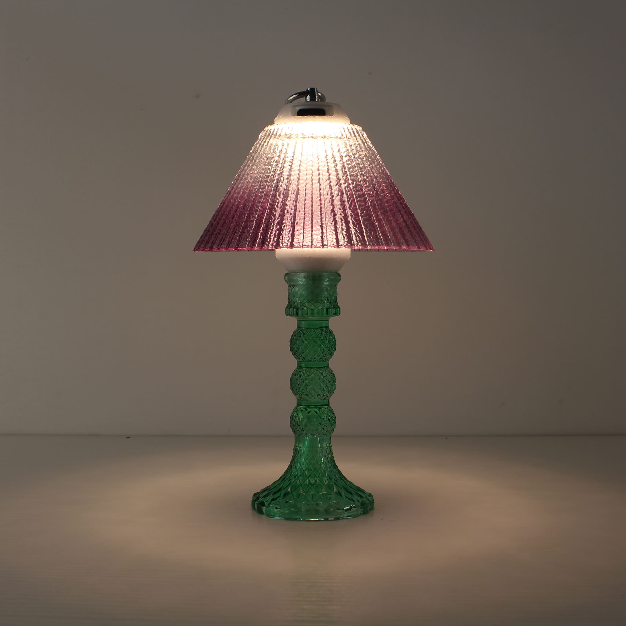 Prism cordless lamp (ON) with cyan base and warm purple gradient shade creating a romantic ambiance.