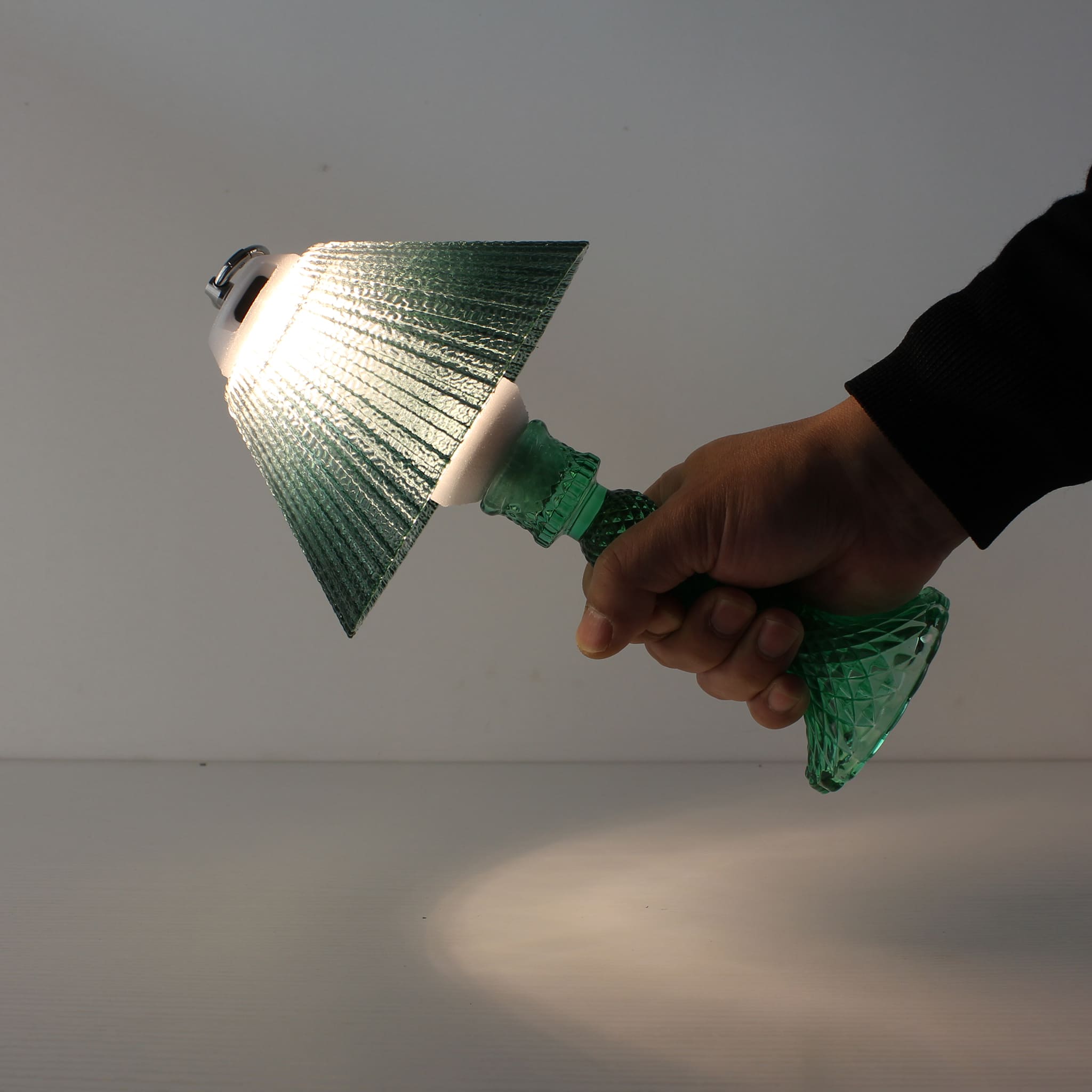 Wide view of the Prism glass lantern (ON) with cyan base, showcasing its soft 360-degree prismatic ambiance.