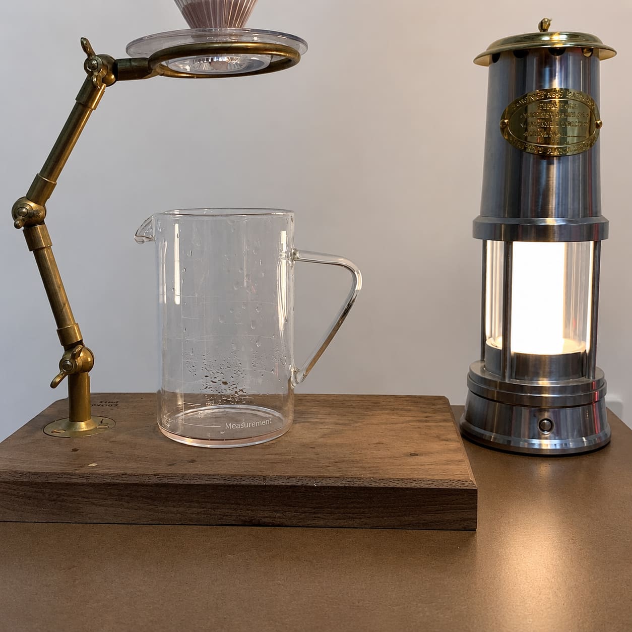 Davy inspired cordless lantern shown beside a coffee dripper for size comparison