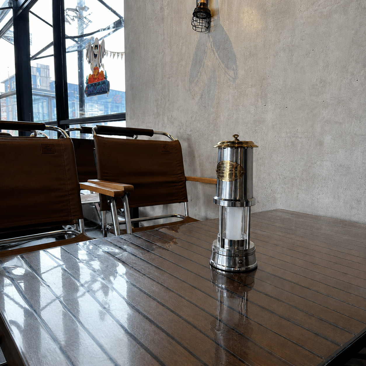 Cordless brass miner's lantern displayed on a café table