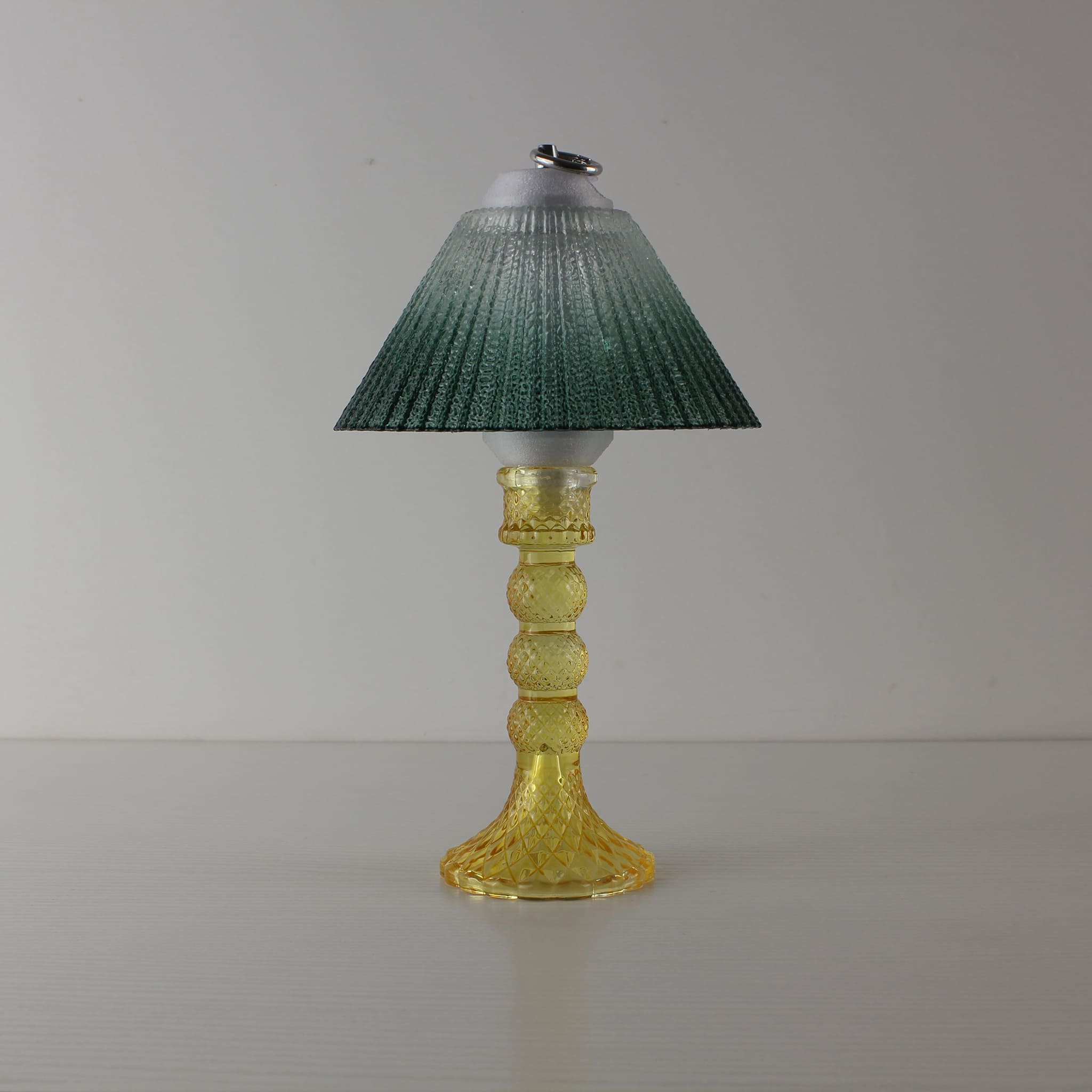 Decorative amber glass lamp (OFF) with green gradient shade, showcasing PETG 3D-printed structural details.
