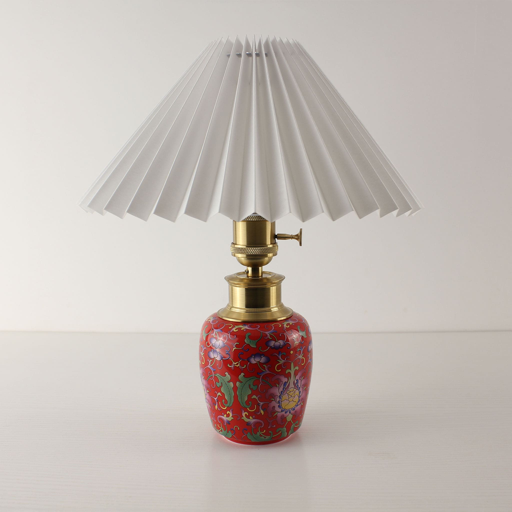 Front view of the enamel ceramic lamp with a white pleated shade (Power Off), showcasing the 3D decorative texture