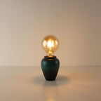 Handcrafted kiln-turned green ceramic cordless table lamp featuring a large round A80 vintage Edison LED bulb with a warm 2700K glow