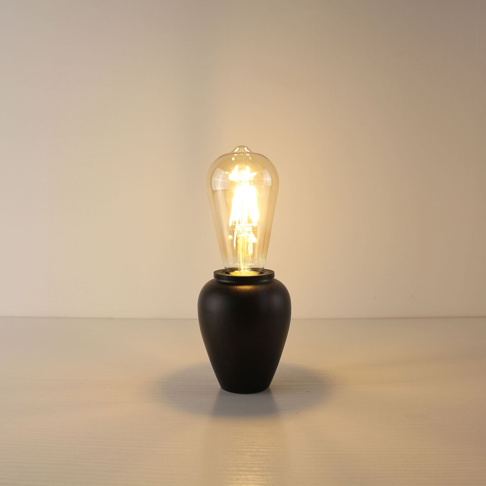 Minimalist rechargeable black tea caddy lamp base featuring a classic teardrop ST64 Edison LED bulb for a sophisticated ambiance