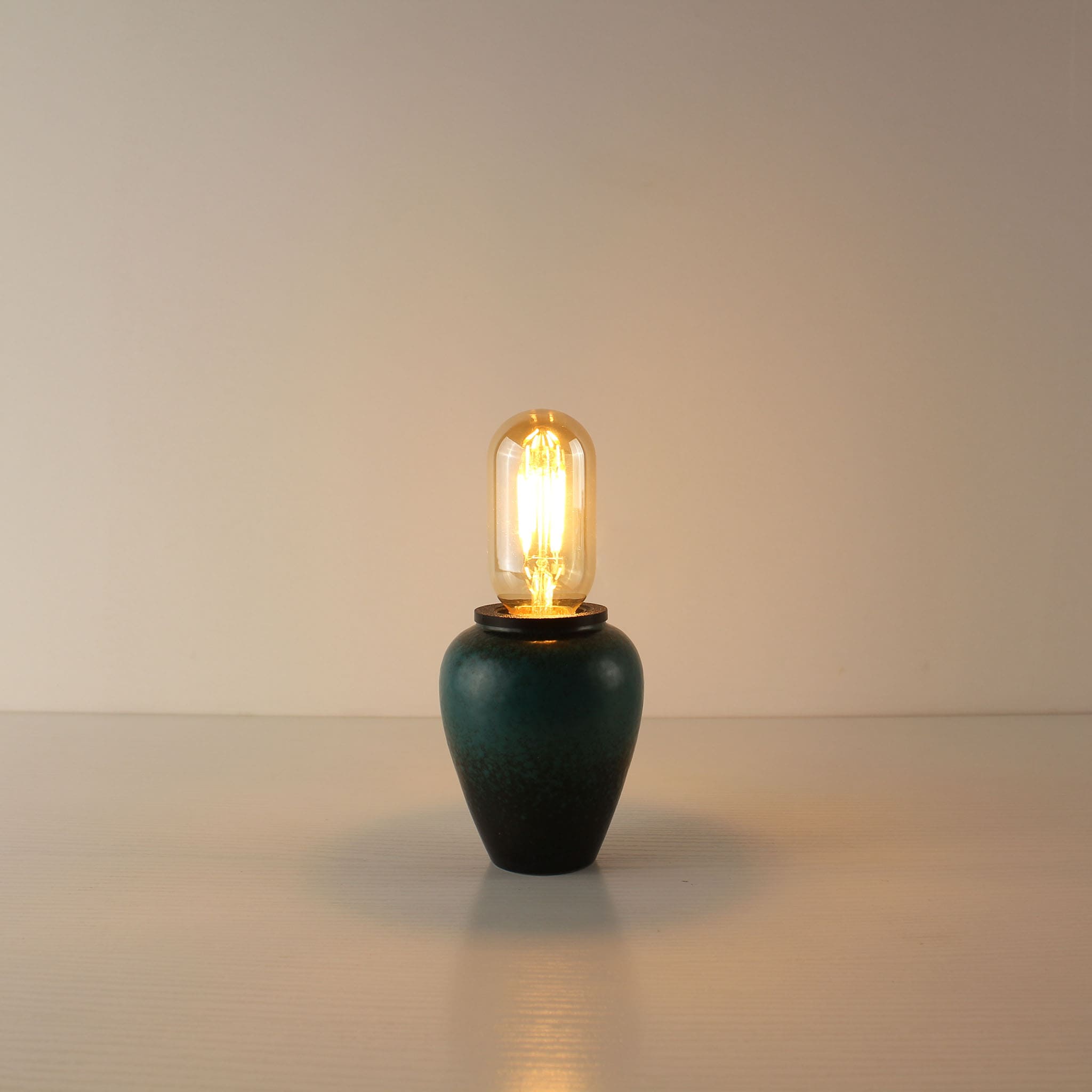 Minimalist portable desk lamp with a handcrafted green ceramic tea caddy base and a sleek T45 tube-shaped vintage LED bulb