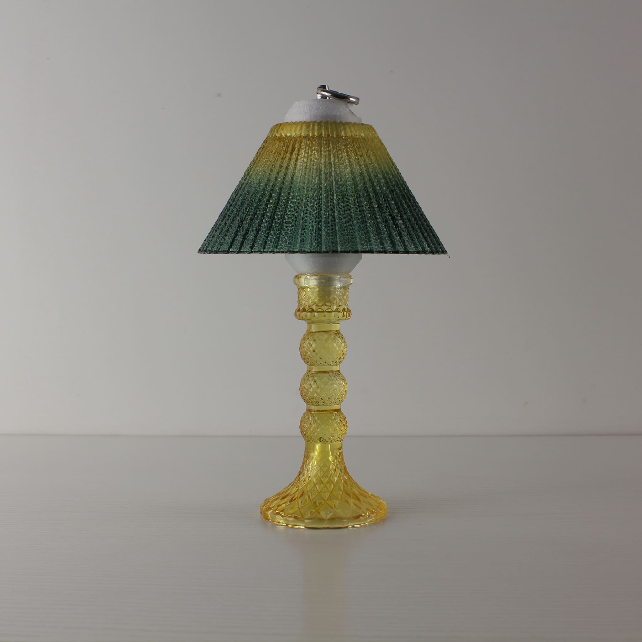 Minimalist yellow table lamp (OFF) with yellow-to-green gradient prismatic shade, perfect for modern home tabletop decor.