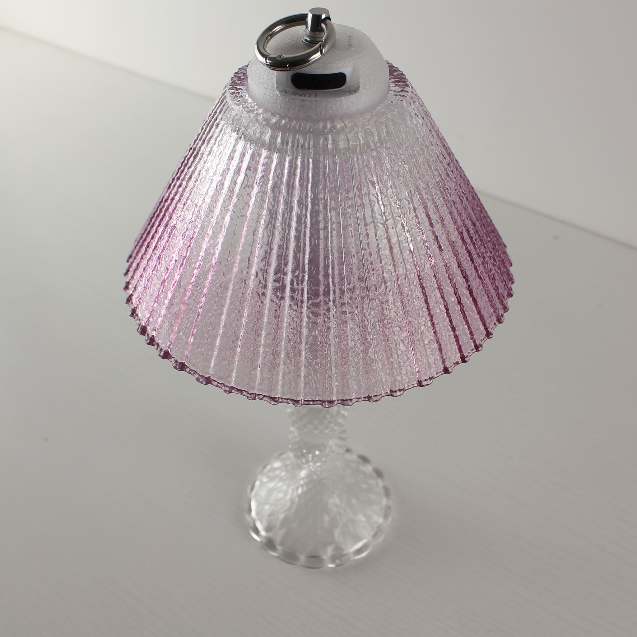 Detail view of the Prism clear lantern featuring an integrated metal ring for easy carrying or hanging as a pendant.