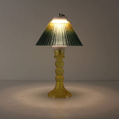 Portable wireless lantern (ON) featuring an amber yellow glass base and sunlit yellow-to-green gradient shade.
