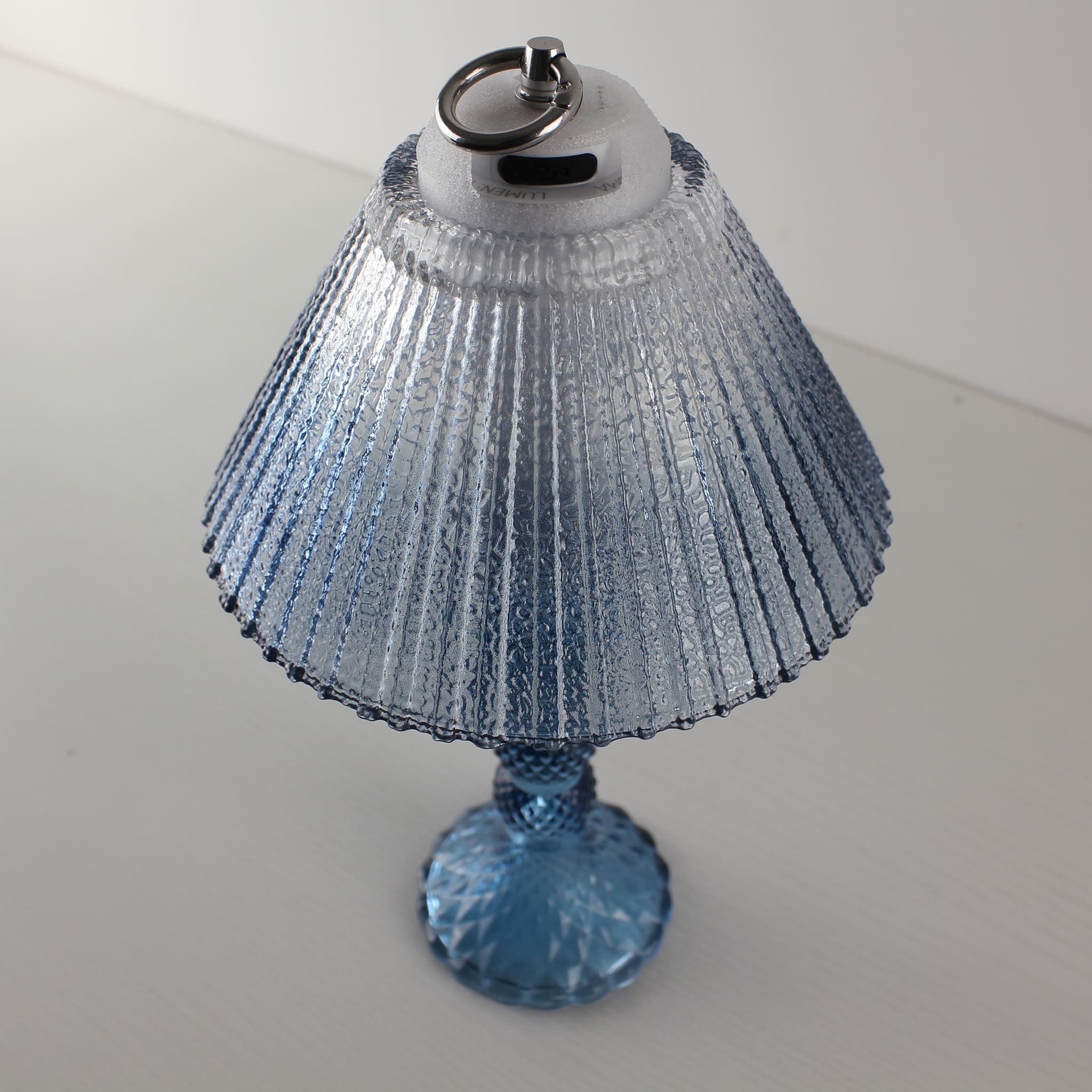 Close-up of the Prism glass lamp's USB-C charging port on the sapphire blue base, compatible with PD60W fast charging.