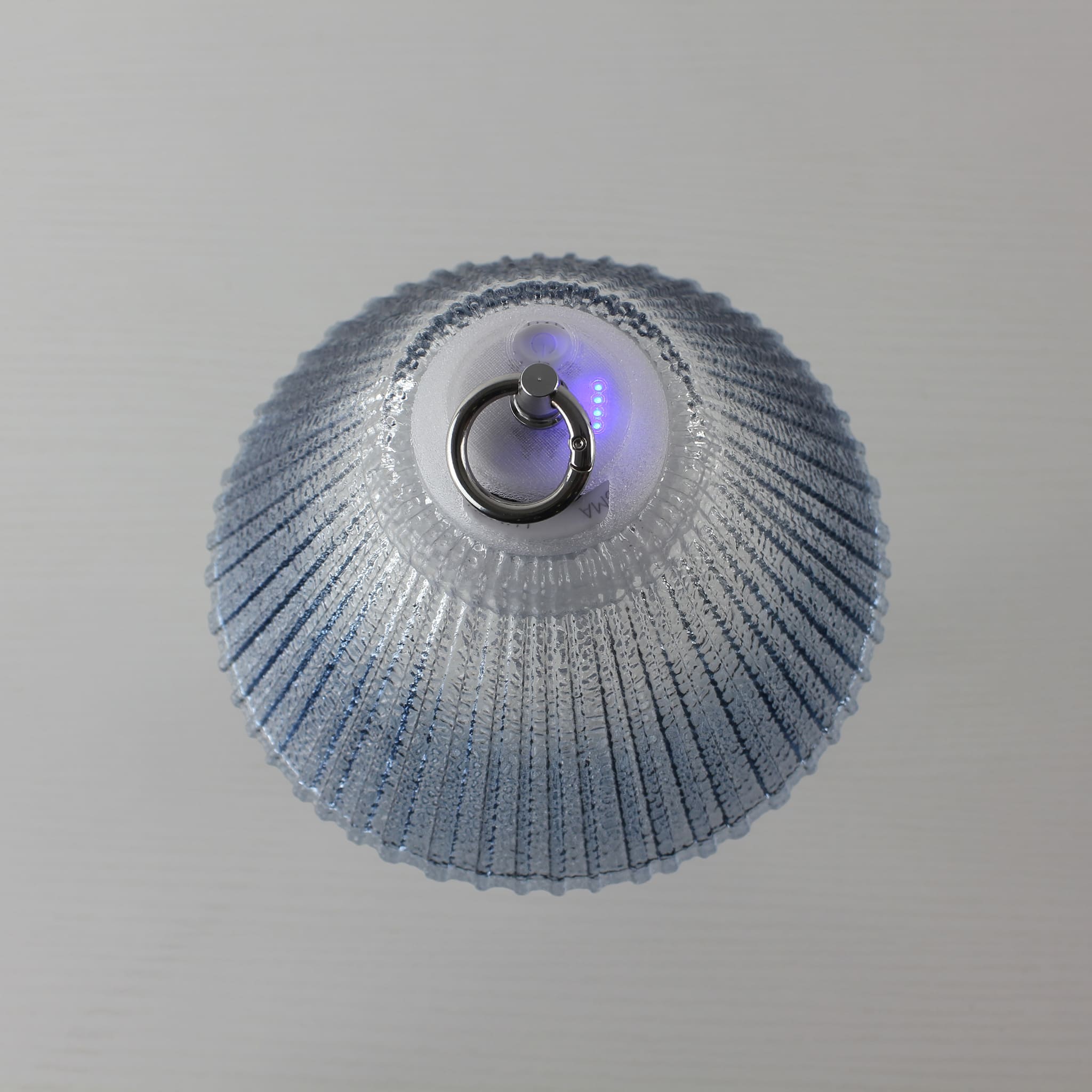 Detail view of the Prism blue lantern's top showing the integrated metal hanging ring and stepless dimming control system.