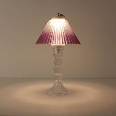 Cordless decorative table lamp (ON) with clear glass base and warm purple gradient shade for romantic ambiance.