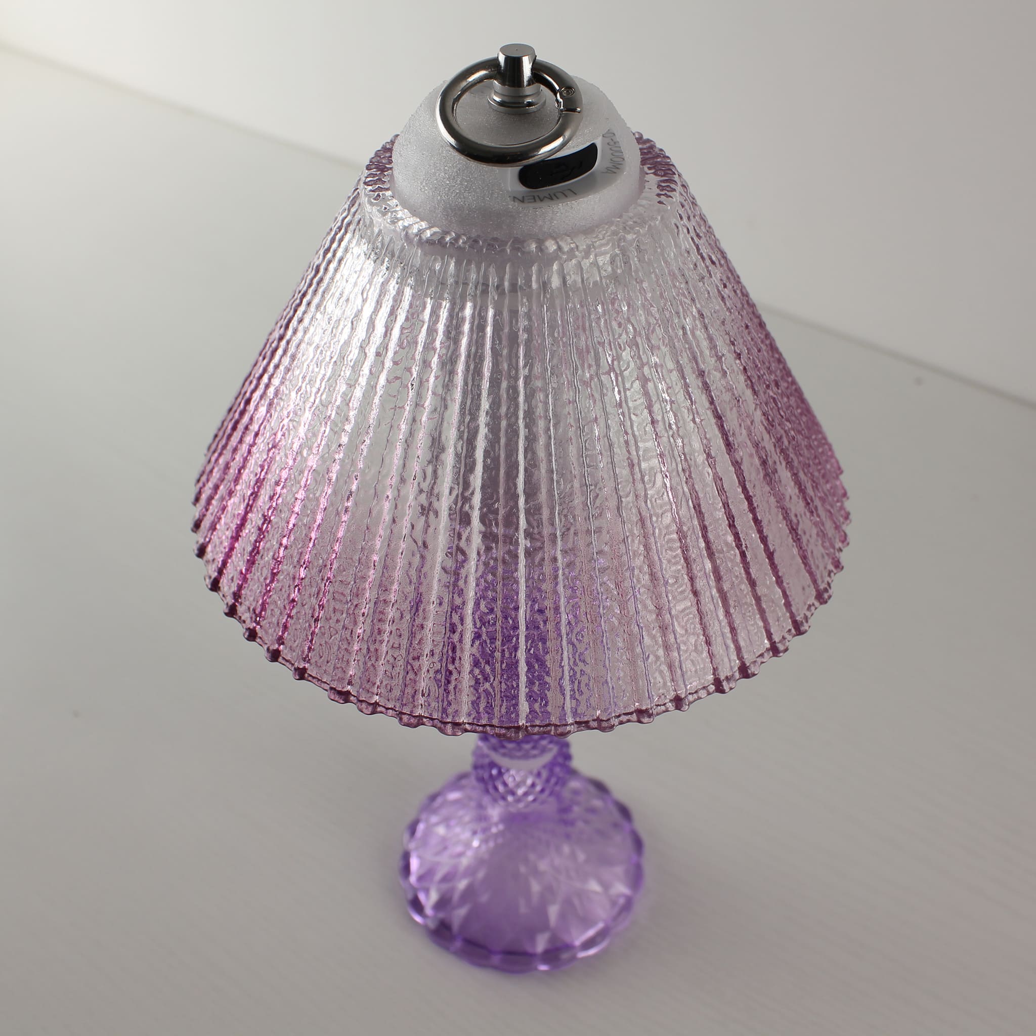 Close-up of the Prism glass lamp's USB-C charging port and stepless dimming control system on the cool purple base.