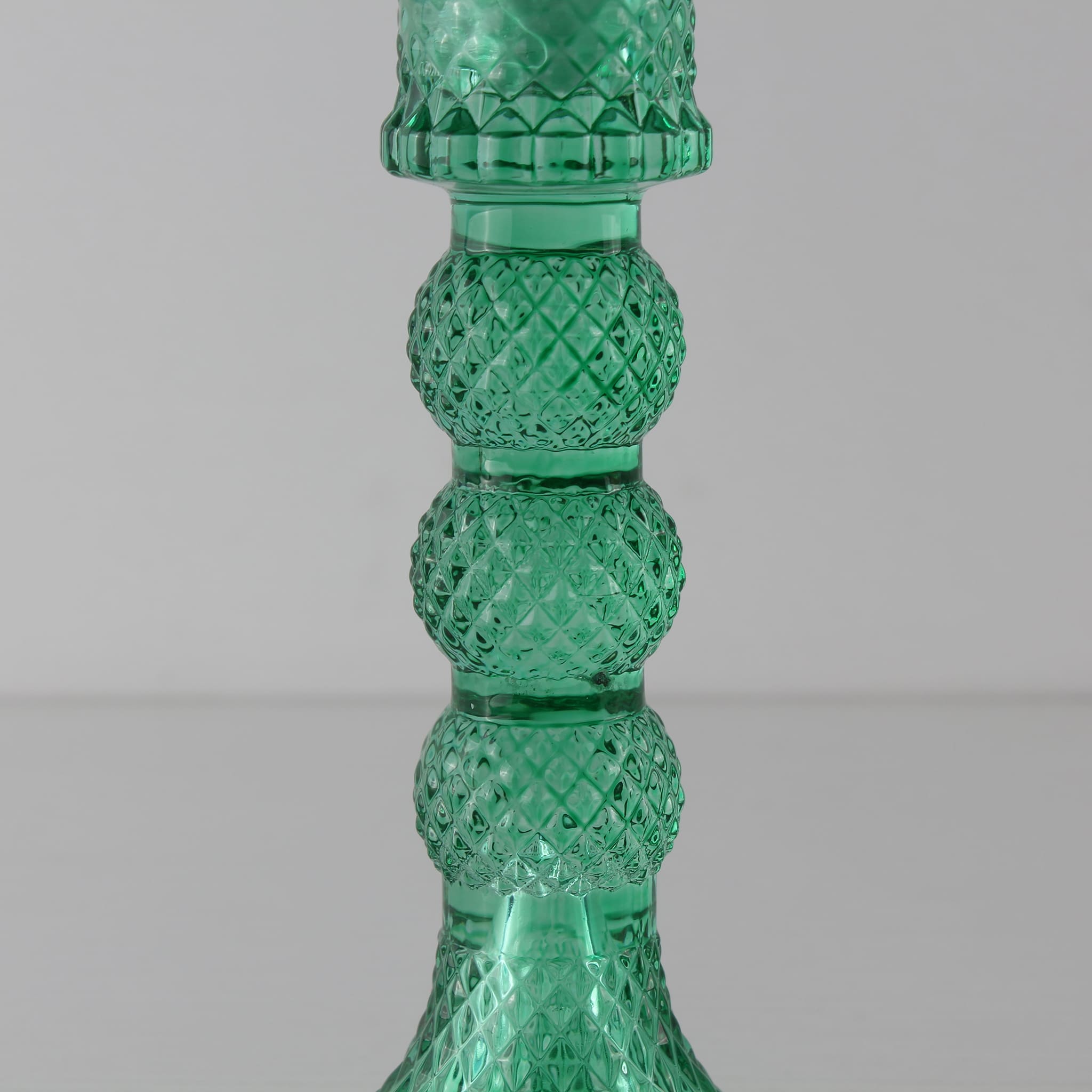 Detailed view of the Prism lantern's faceted glass base