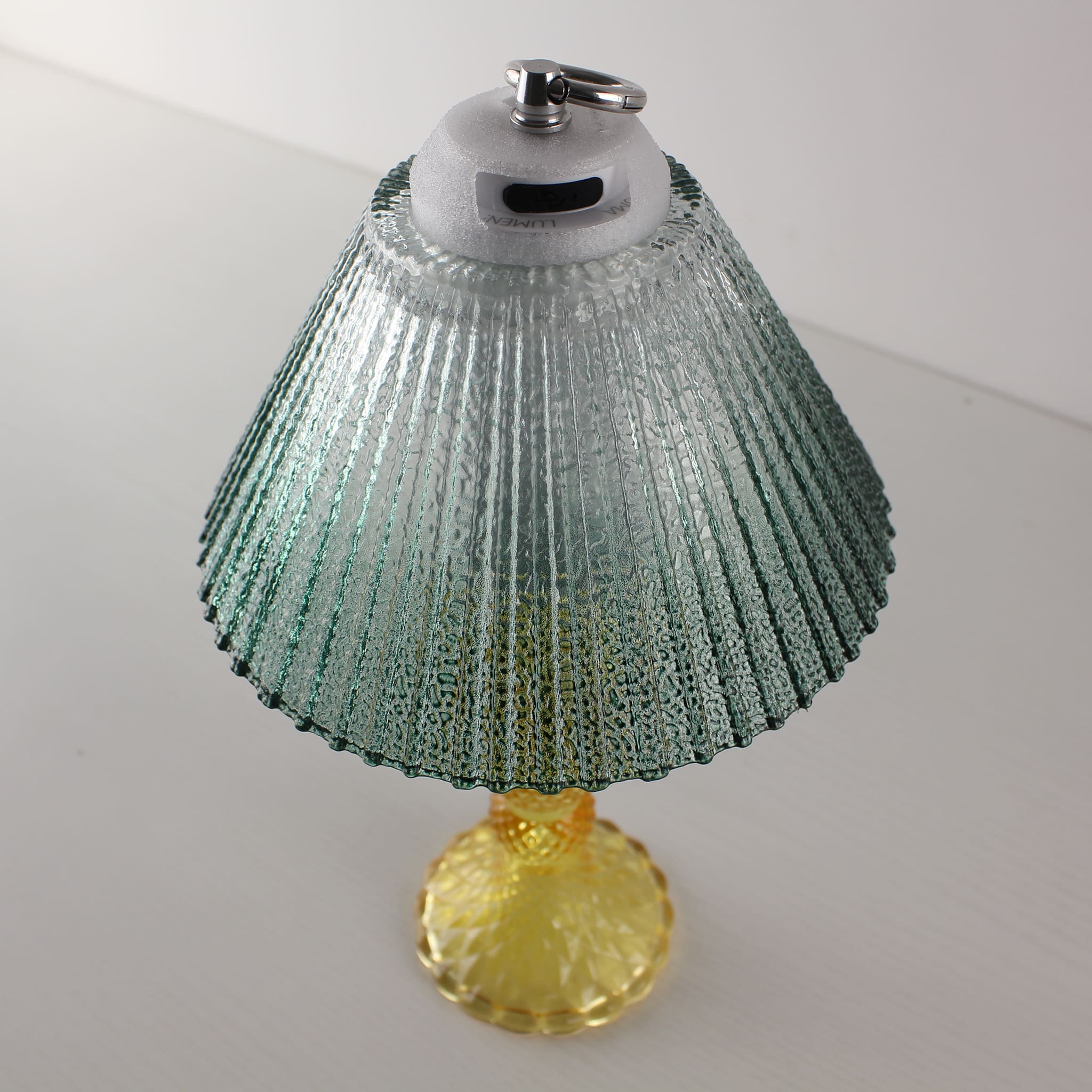 Close-up of the Prism glass lamp's USB-C charging port and stepless dimming control system on the yellow base.