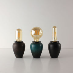 Comparison of three rechargeable ceramic table lamps showing the rust, green, and black tea caddy bases with clear vintage LED bulbs