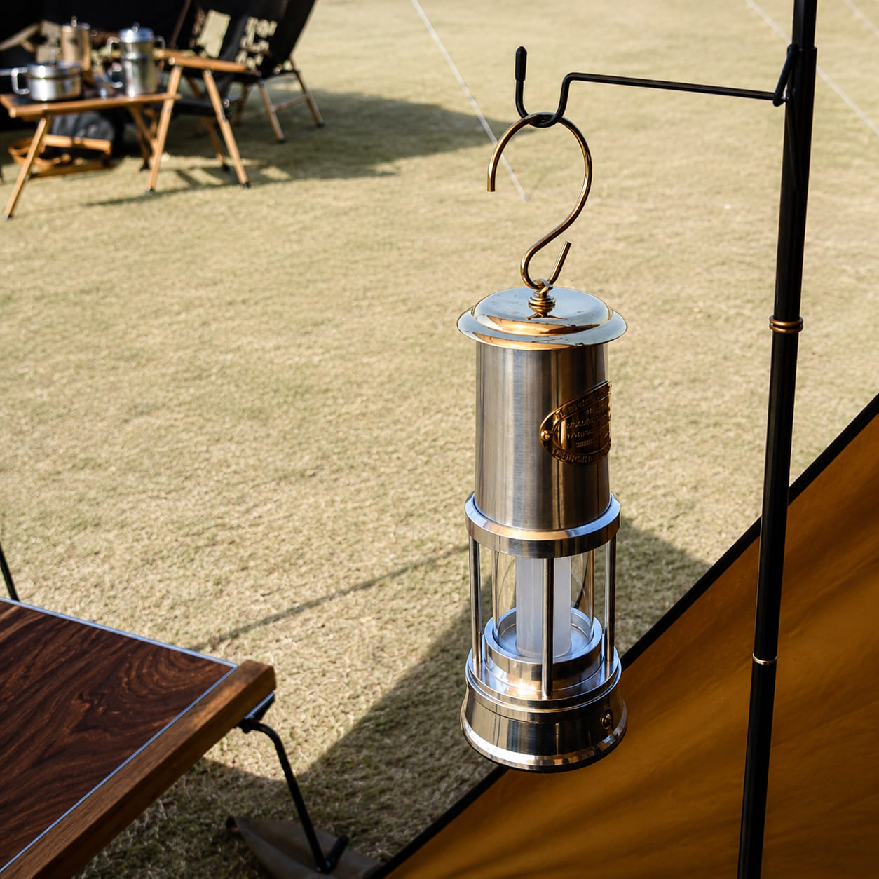 Rechargeable Davy miner's lantern hanging beside a camping tent