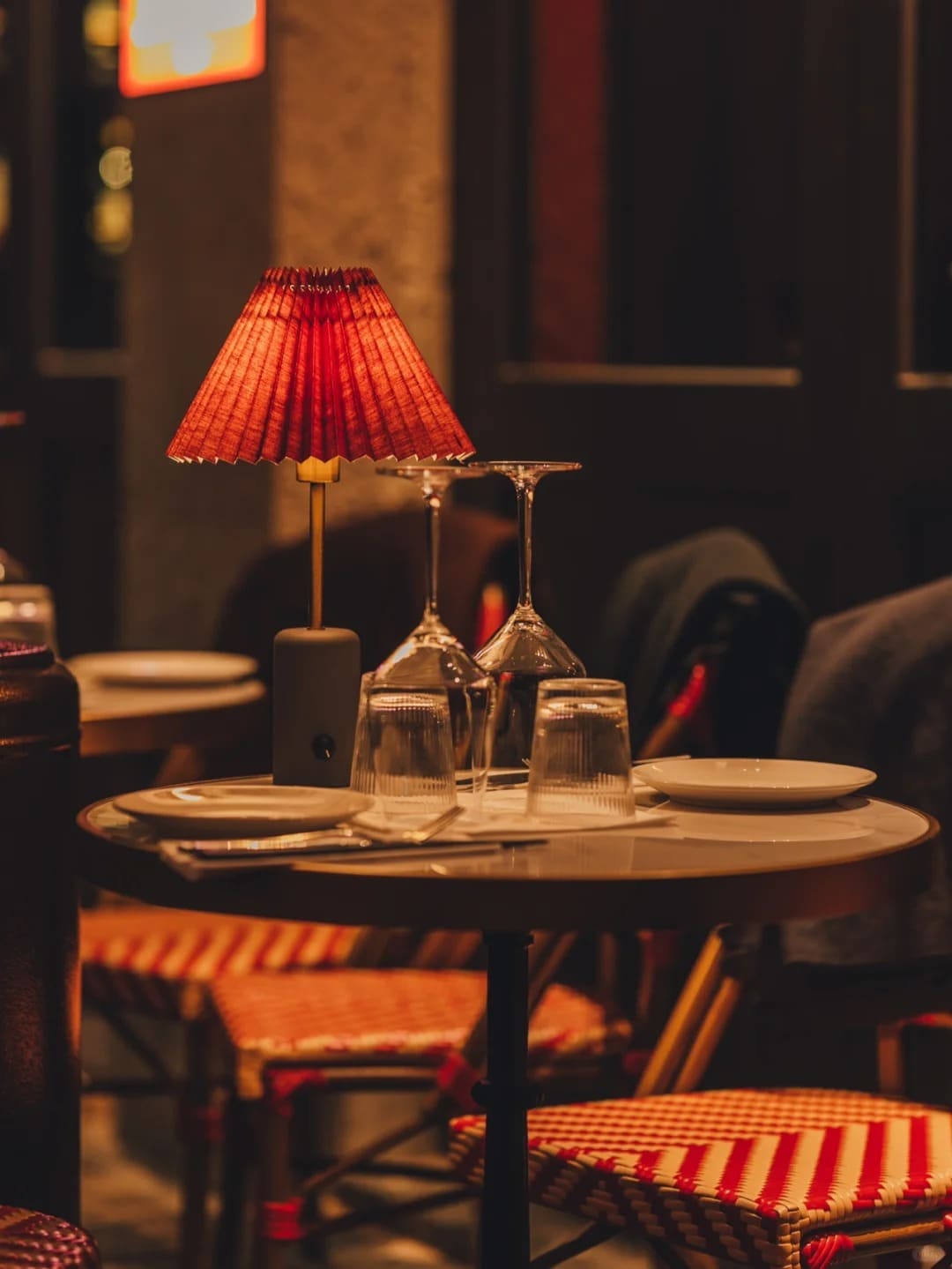 Rechargeable pleated shade table lamp creating cozy bistro lighting atmosphere