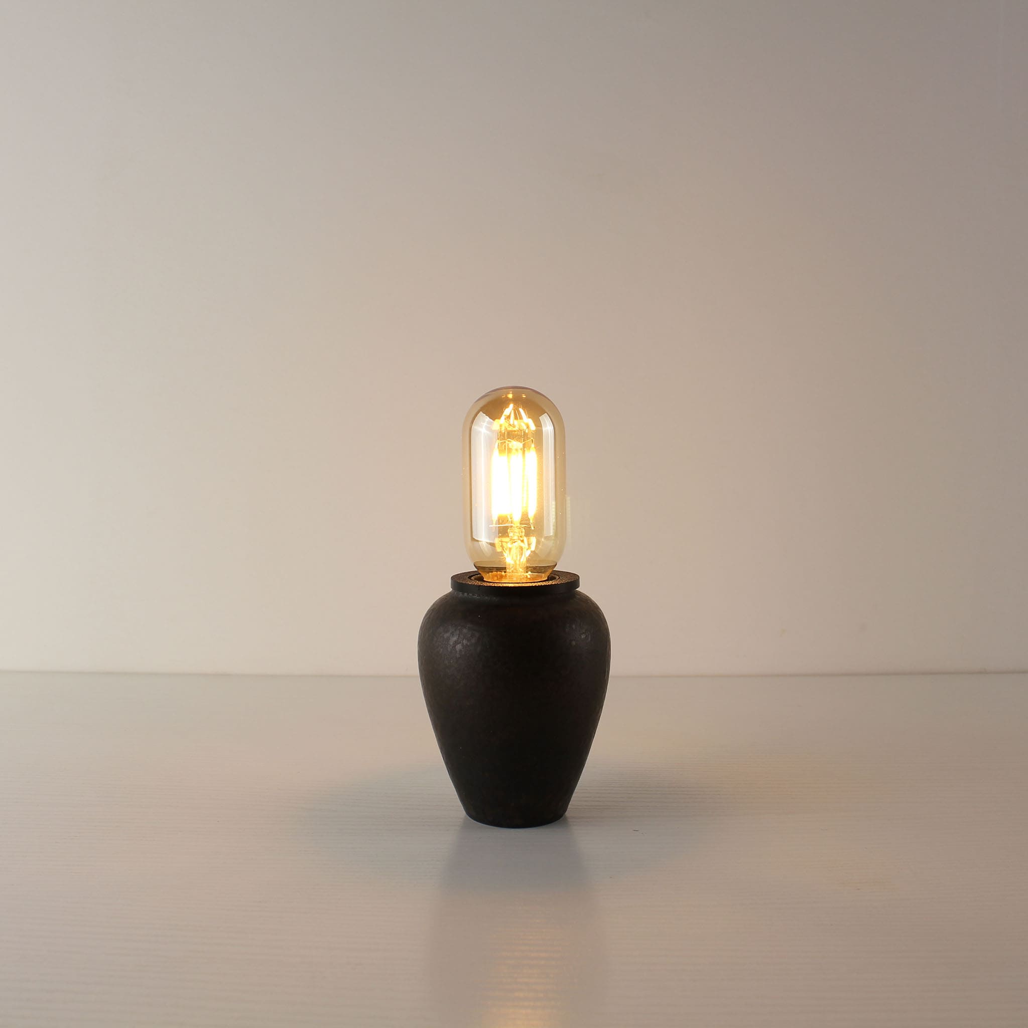 Rustic handcrafted ceramic portable lamp in industrial rust finish, featuring a compact T45 tube-shaped vintage LED bulb