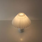 Top-down perspective of the glowing pleated shade providing 360-degree soft ambient light, ideal for restaurant tables.
