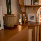 Vintage inspired cordless brass lantern on a wooden bookshelf