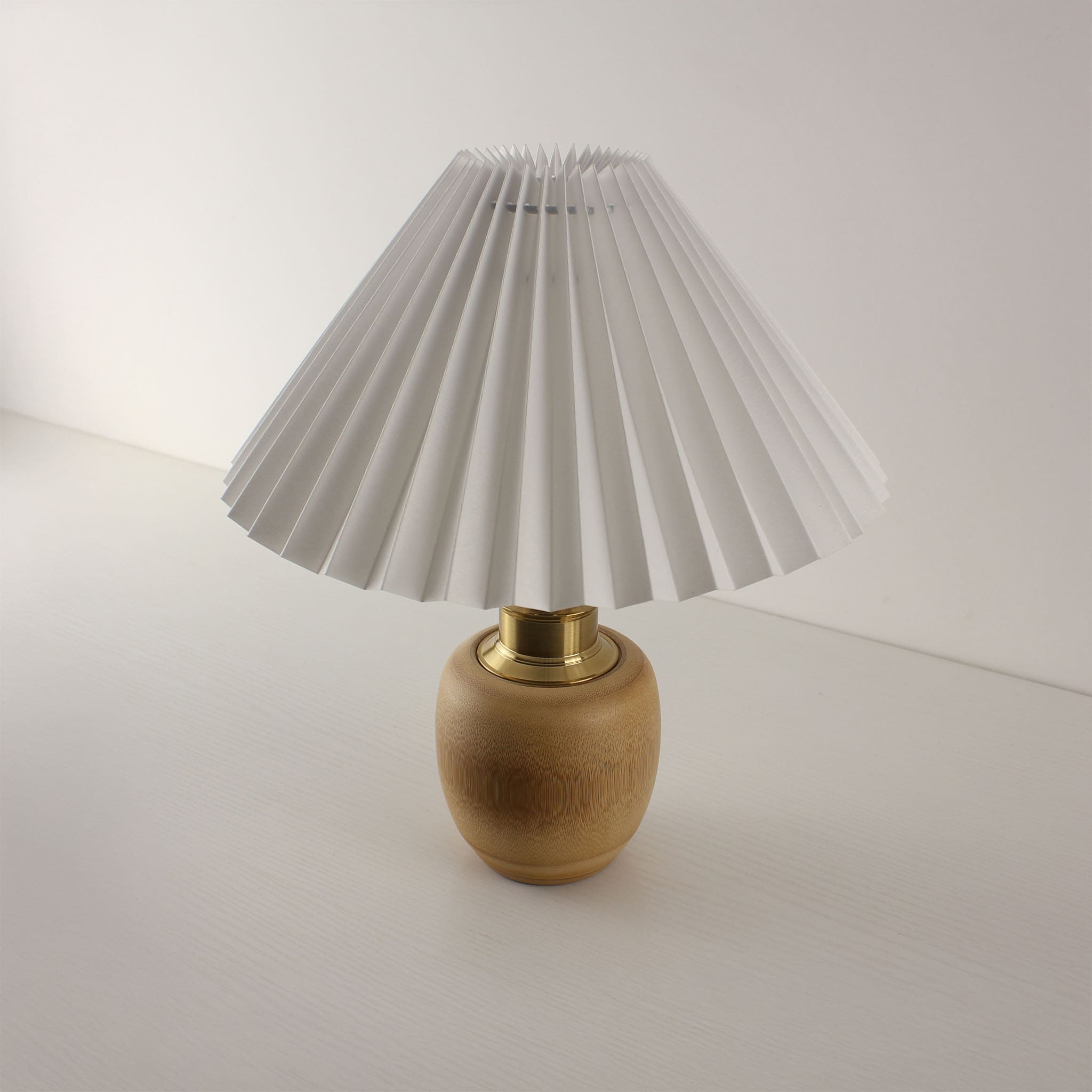 Side view of a Wabi-Sabi style bamboo lamp with white pleated shade, eco-friendly portable light for living room decor
